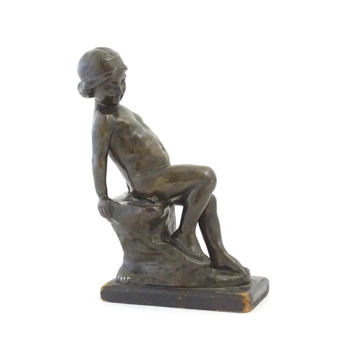 1099 - An early 20thC cast figure depicting a young boy on a rock plinth. Indistinctly signed to base Flore... 