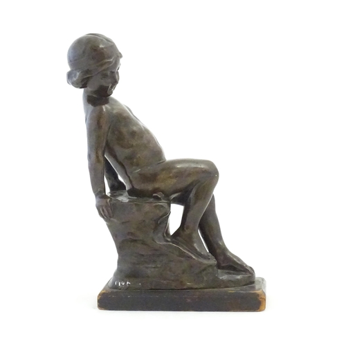 1099 - An early 20thC cast figure depicting a young boy on a rock plinth. Indistinctly signed to base Flore... 