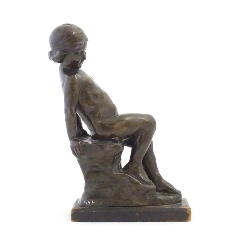 1099 - An early 20thC cast figure depicting a young boy on a rock plinth. Indistinctly signed to base Flore... 