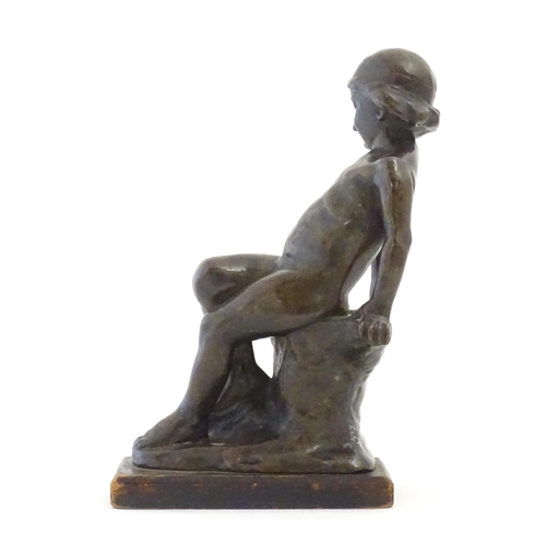 1099 - An early 20thC cast figure depicting a young boy on a rock plinth. Indistinctly signed to base Flore... 