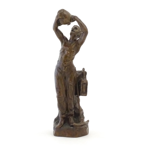 1100 - A 20thC cast sculpture after Richard Aurili, depicting a miner drinking from a water vessel, with la... 