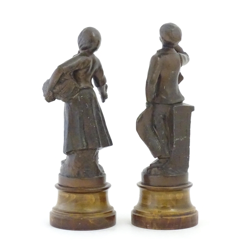 1102 - A pair of 20thC French spelter figures depicting street vendors comprising Flower seller and Newspap... 