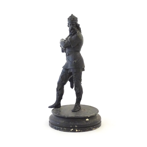 1103 - A 20thC spelter sculpture modelled as a medieval king. Raised on a turned wooden base. Approx. 15 3/... 