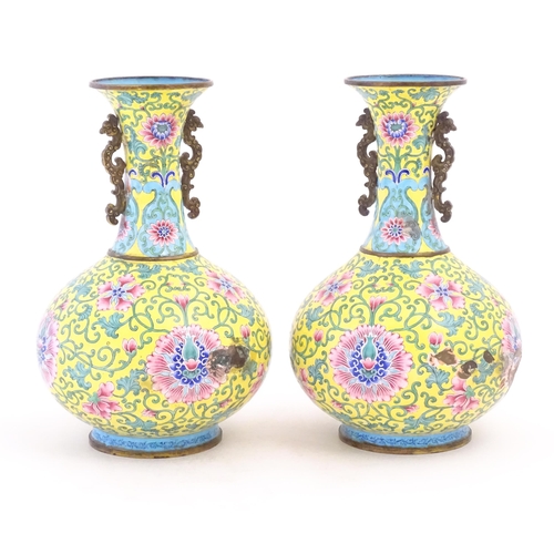 1124 - A pair of Oriental cloisonne vases with twin handles, yellow ground decorated with flowers and scrol... 