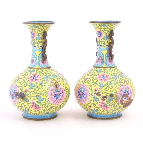 1124 - A pair of Oriental cloisonne vases with twin handles, yellow ground decorated with flowers and scrol... 