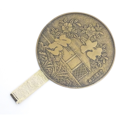 1132 - A Japanese kagami / hand mirror decorated with flowers, foliage, character script etc. Approx. 10