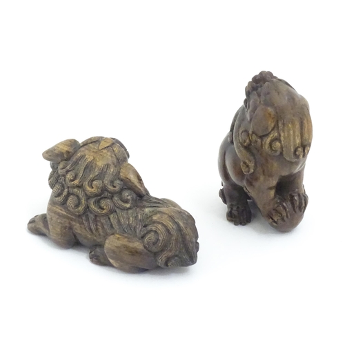 1137 - Two Japanese carved hardwood netsukes modelled as guardian lions / foo dogs. Both signed under. Larg... 