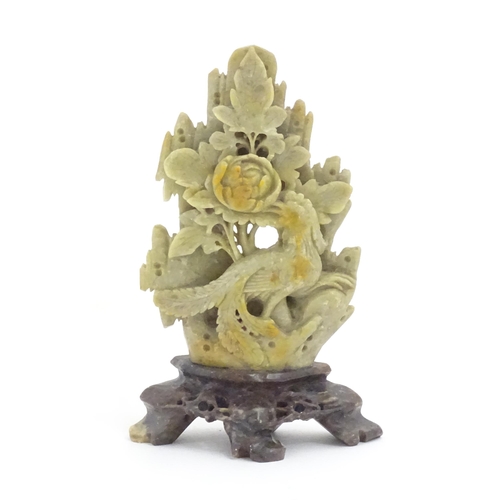 1138 - An Oriental soapstone carving depicting a bird, flower and foliage. Approx. 6