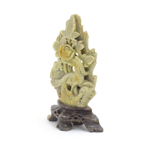 1138 - An Oriental soapstone carving depicting a bird, flower and foliage. Approx. 6