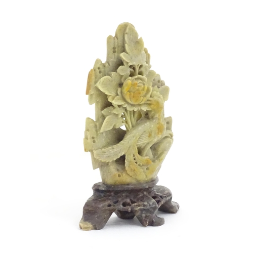 1138 - An Oriental soapstone carving depicting a bird, flower and foliage. Approx. 6