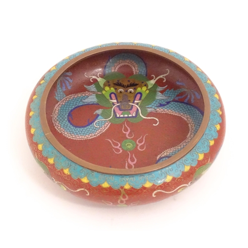 1143 - An Oriental cloisonne bowl decorated with dragons and flaming pearls. Marked under. Approx. 8