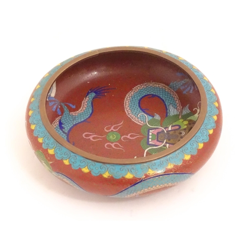 1143 - An Oriental cloisonne bowl decorated with dragons and flaming pearls. Marked under. Approx. 8