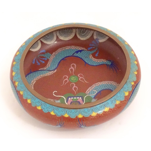 1143 - An Oriental cloisonne bowl decorated with dragons and flaming pearls. Marked under. Approx. 8