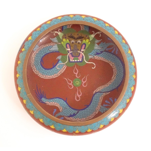 1143 - An Oriental cloisonne bowl decorated with dragons and flaming pearls. Marked under. Approx. 8