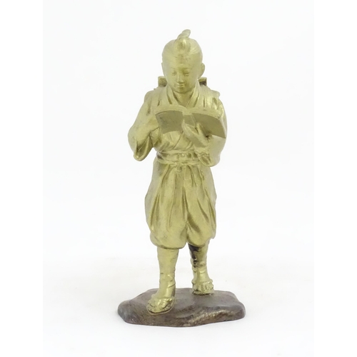 1147 - An Oriental cast sculpture modelled as a scholar reading a book. Approx. 10 1/4