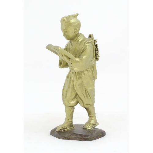 1147 - An Oriental cast sculpture modelled as a scholar reading a book. Approx. 10 1/4