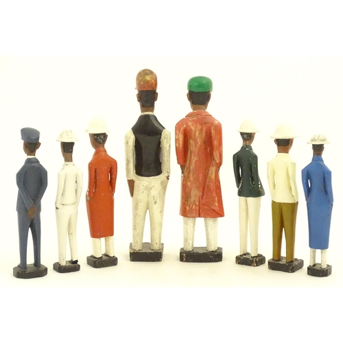 1159 - A quantity of 20thC carved hardwood African colonial figures with polychrome decoration. Largest app... 