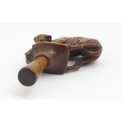 1167 - An early 19thC treen boxwood pipe tamper modelled as a greyhound dog retrieving a hare. Approx. 3 1/... 