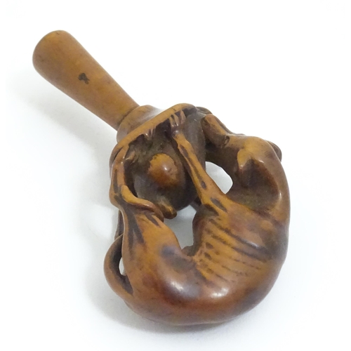 1167 - An early 19thC treen boxwood pipe tamper modelled as a greyhound dog retrieving a hare. Approx. 3 1/... 