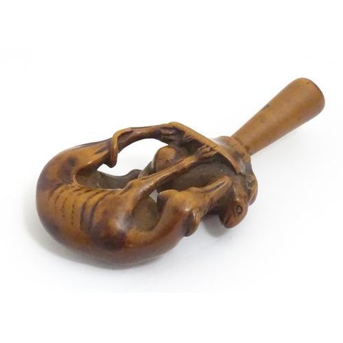 1167 - An early 19thC treen boxwood pipe tamper modelled as a greyhound dog retrieving a hare. Approx. 3 1/... 