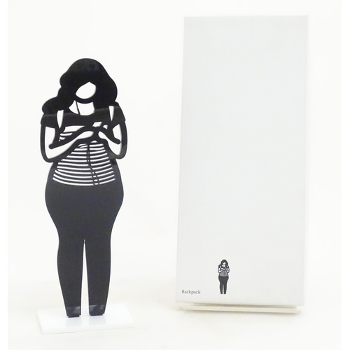 1176 - A 21stC laser cut acrylic statuette titled Backpack. Approx. 9 1/4