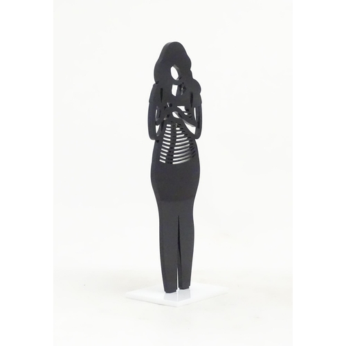 1176 - A 21stC laser cut acrylic statuette titled Backpack. Approx. 9 1/4