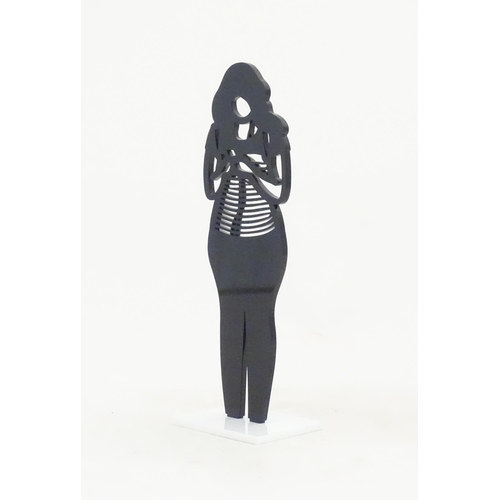 1176 - A 21stC laser cut acrylic statuette titled Backpack. Approx. 9 1/4