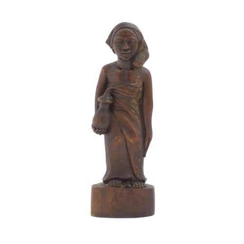 1184 - Ethnographic / Native / Tribal: An African carved wood figure modelled as a lady holding a vessel. A... 