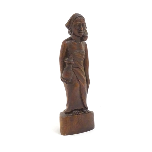 1184 - Ethnographic / Native / Tribal: An African carved wood figure modelled as a lady holding a vessel. A... 