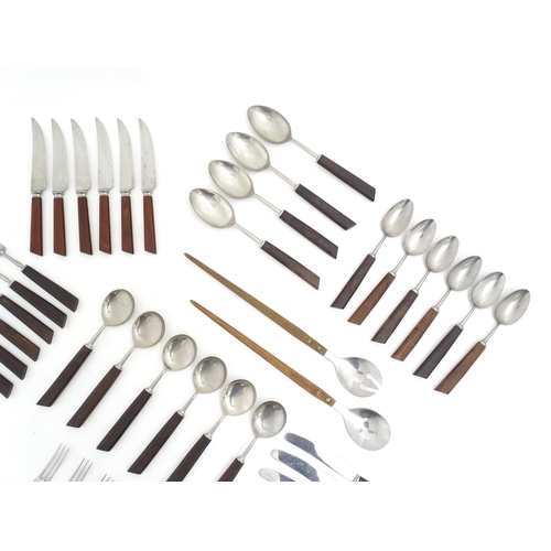 1194 - A quantity of vintage / retro wooden handled flatware / cutlery to include knives, forks, spoons, et... 