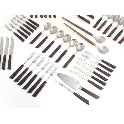 1194 - A quantity of vintage / retro wooden handled flatware / cutlery to include knives, forks, spoons, et... 