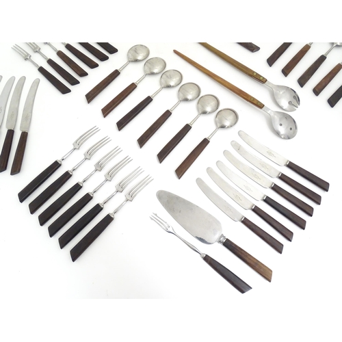 1194 - A quantity of vintage / retro wooden handled flatware / cutlery to include knives, forks, spoons, et... 