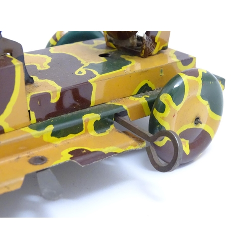 1456 - Toys: An early 20thC tin plate clockwork military vehicle with camouflage detail, two seated soldier... 