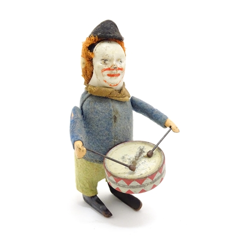 1459 - Toys: Three 20thC clockwork / wind up toys comprising a Schuco model of a clown playing the drum, a ... 