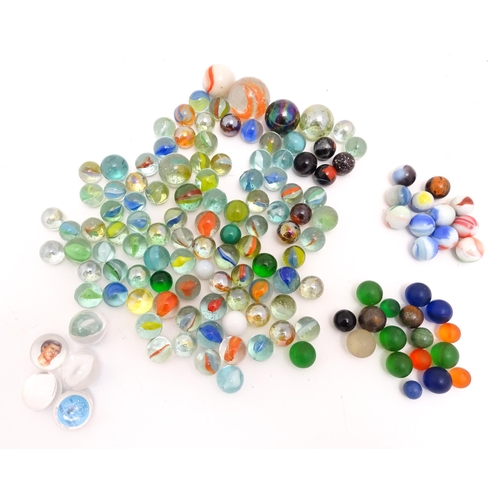 1461 - Toys: A quantity of assorted glass marbles, many with colours twists. Largest approx. 1