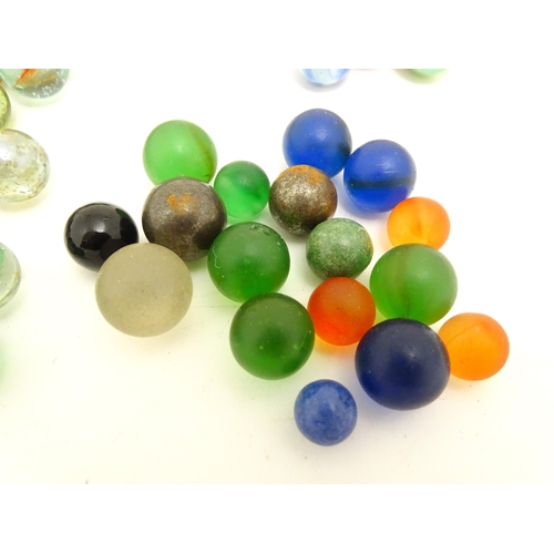 1461 - Toys: A quantity of assorted glass marbles, many with colours twists. Largest approx. 1