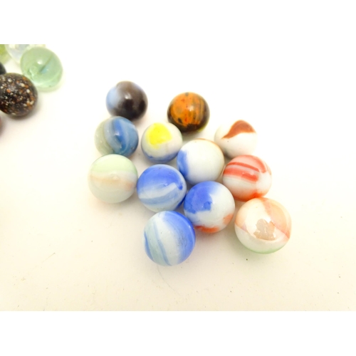 1461 - Toys: A quantity of assorted glass marbles, many with colours twists. Largest approx. 1