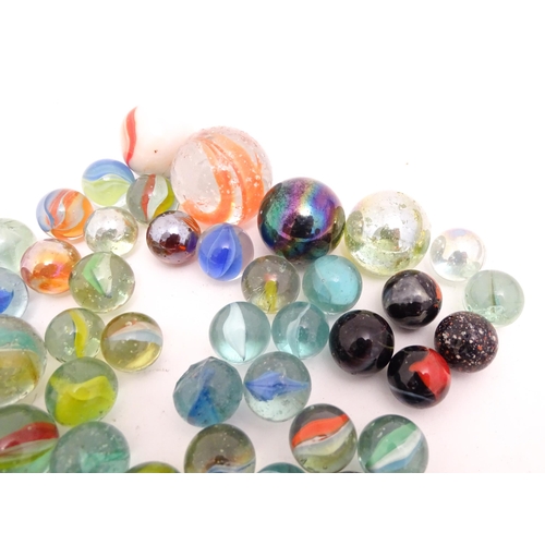 1461 - Toys: A quantity of assorted glass marbles, many with colours twists. Largest approx. 1