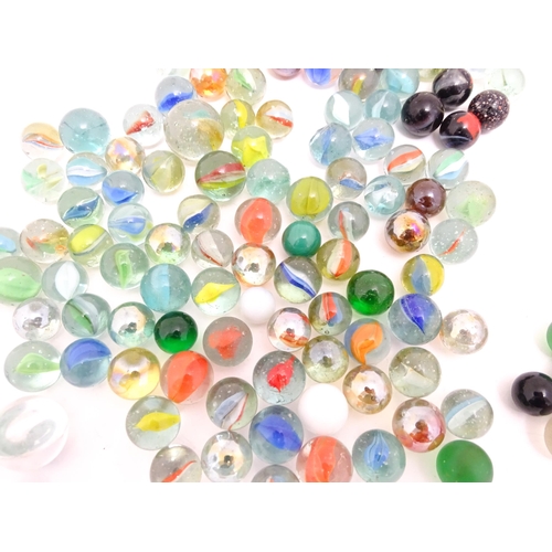 1461 - Toys: A quantity of assorted glass marbles, many with colours twists. Largest approx. 1