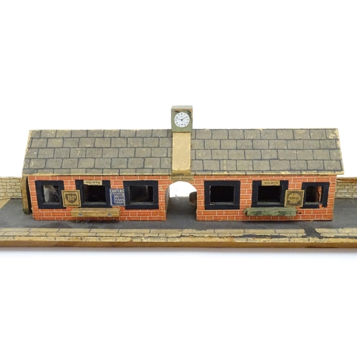 1468 - Toys: A 20thC scratch built wooden model railway station / platform with various adverts for Shell, ... 