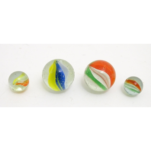 1469 - A quantity of assorted glass marbles, many with colours twists. Largest approx. 1