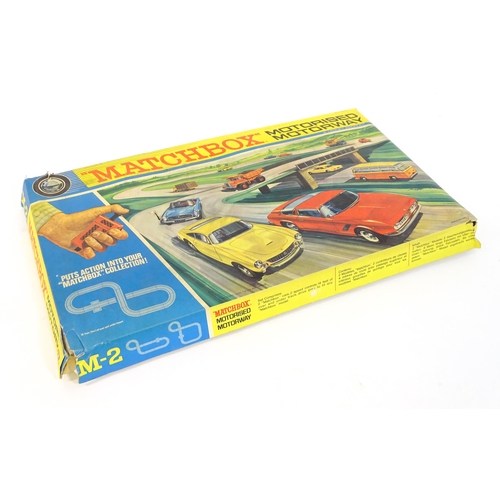 1476 - Toy: A boxed mid 20thC Lesney Matchbox M-2 Motorised Motorway set, containing boxed and loose vehicl... 