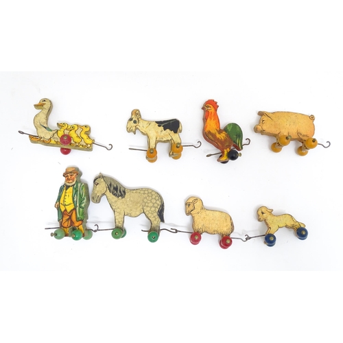 1482 - Toys: An early 20thC Chad Valley pull along farmer and animals with troughs. Together with ABC of an... 
