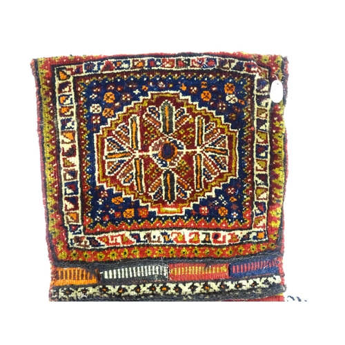 1532 - Rug : A woollen saddle bag style rug, decorated with stylised floral and geometric motifs. Approx. 3... 