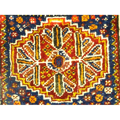 1532 - Rug : A woollen saddle bag style rug, decorated with stylised floral and geometric motifs. Approx. 3... 