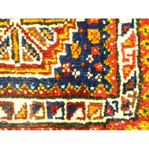 1532 - Rug : A woollen saddle bag style rug, decorated with stylised floral and geometric motifs. Approx. 3... 