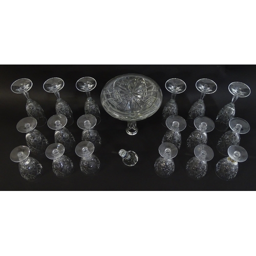 303 - A large quantity of cut glass / crystal glassware to include champagne flutes,  assorted drinking gl... 