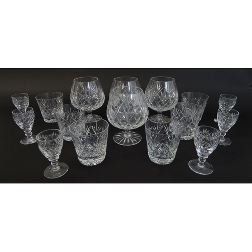 303 - A large quantity of cut glass / crystal glassware to include champagne flutes,  assorted drinking gl... 