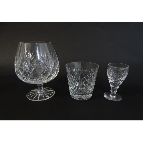 303 - A large quantity of cut glass / crystal glassware to include champagne flutes,  assorted drinking gl... 