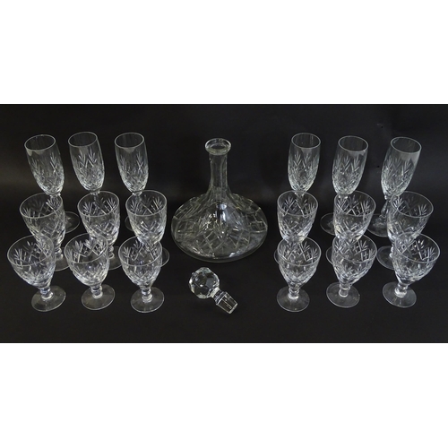 303 - A large quantity of cut glass / crystal glassware to include champagne flutes,  assorted drinking gl... 